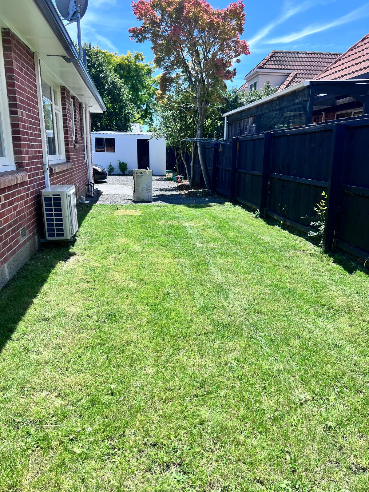 The same side lawn after mowing and edging