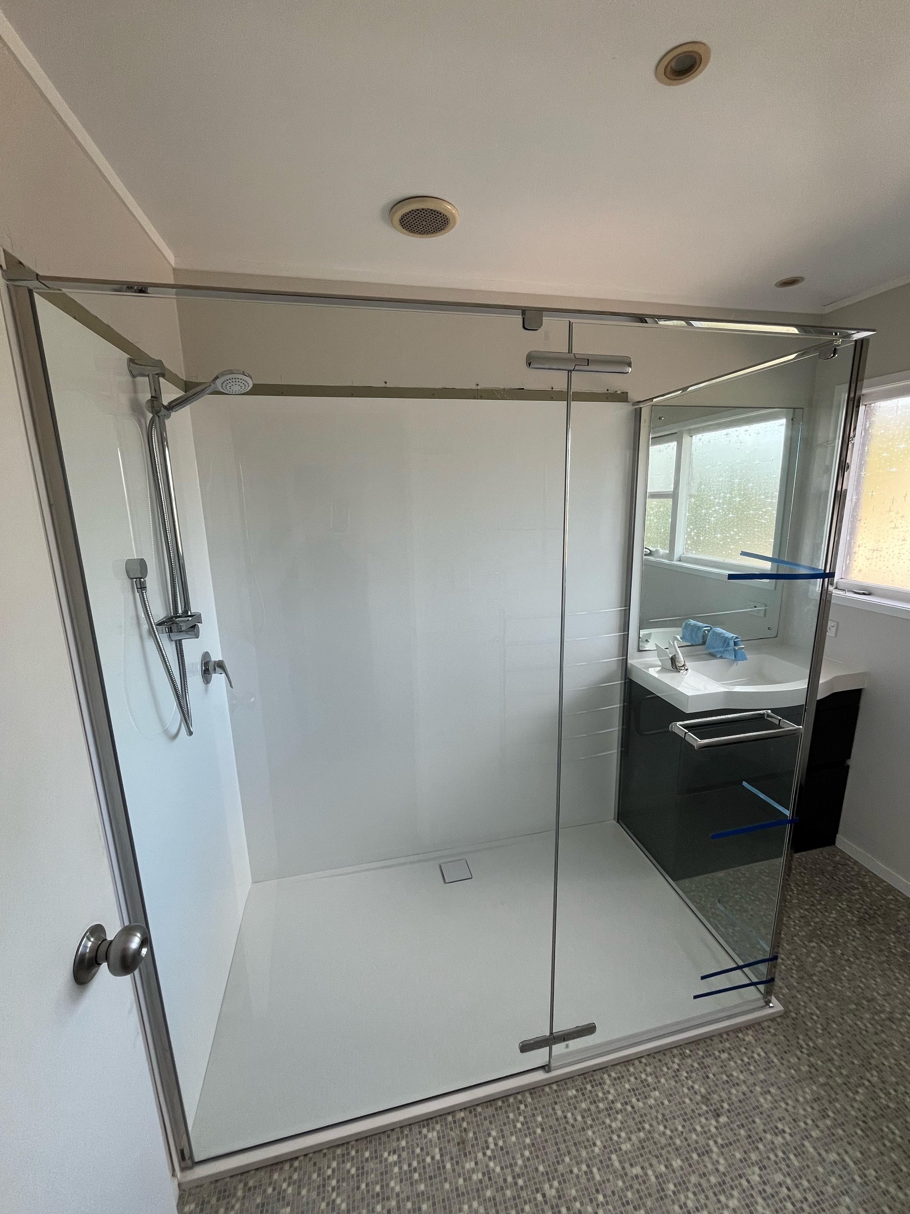 Completed bathroom renovation with recessed electrical lighting