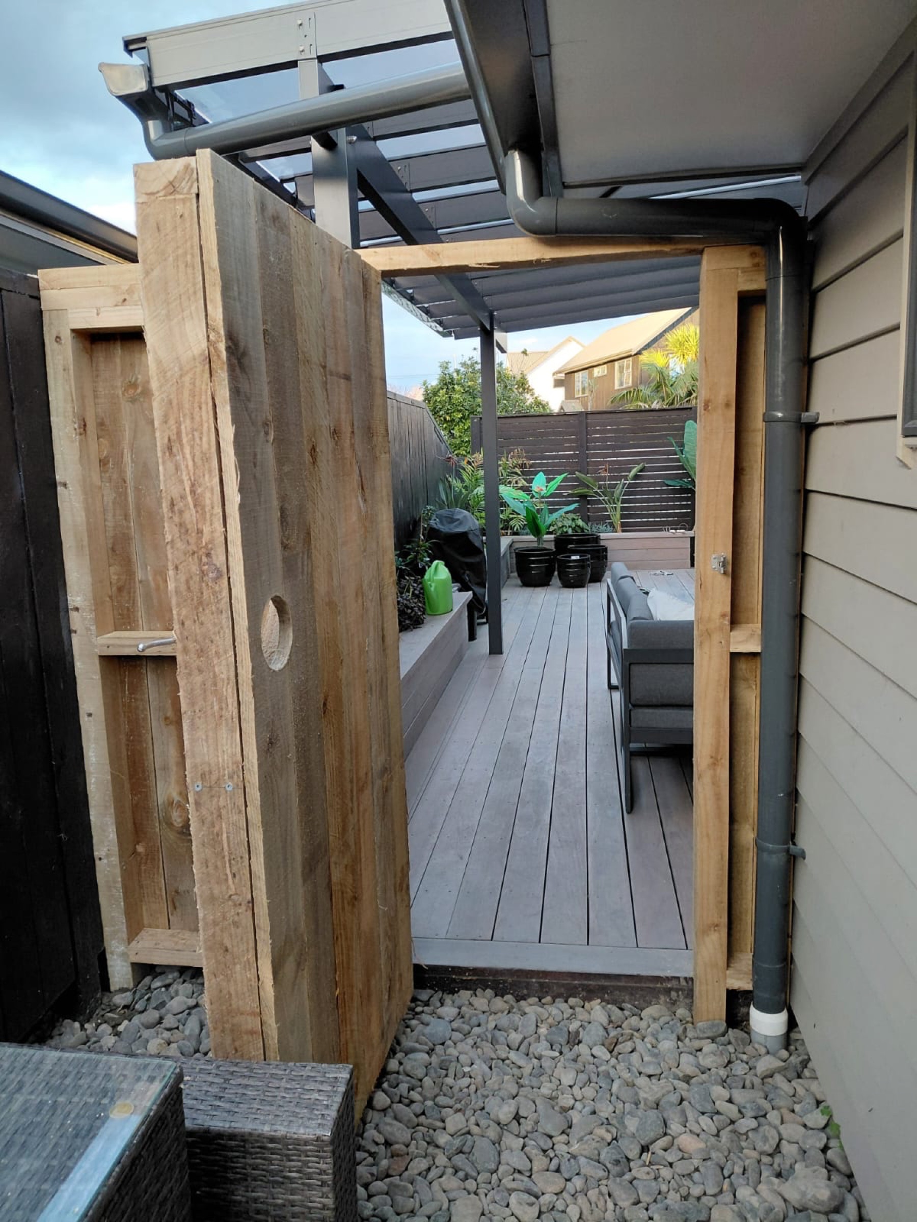 Timber gate opening onto a covered deck